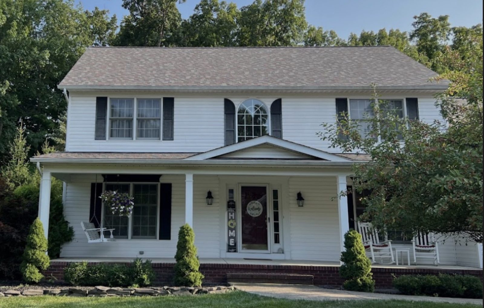 Residential exterior showing windows, gutters, and trim after exterior improvement work